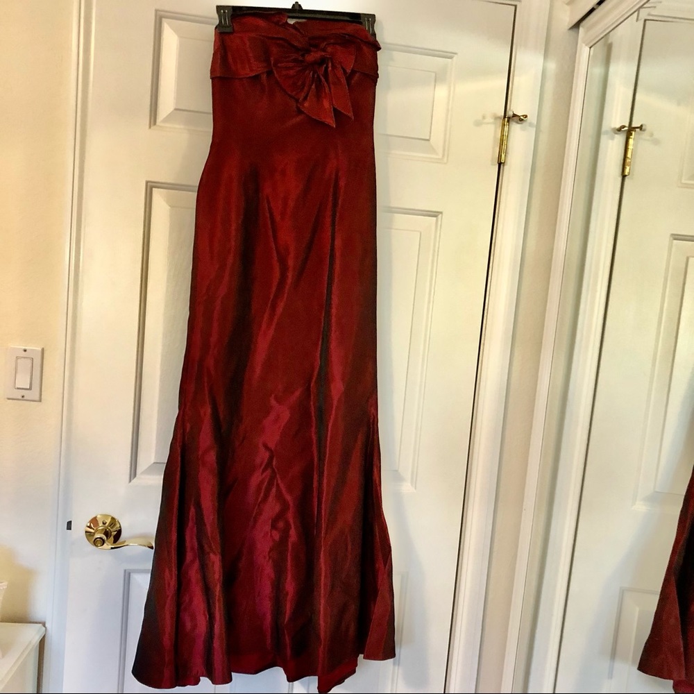 Maroon trumpet gown with bow at chest